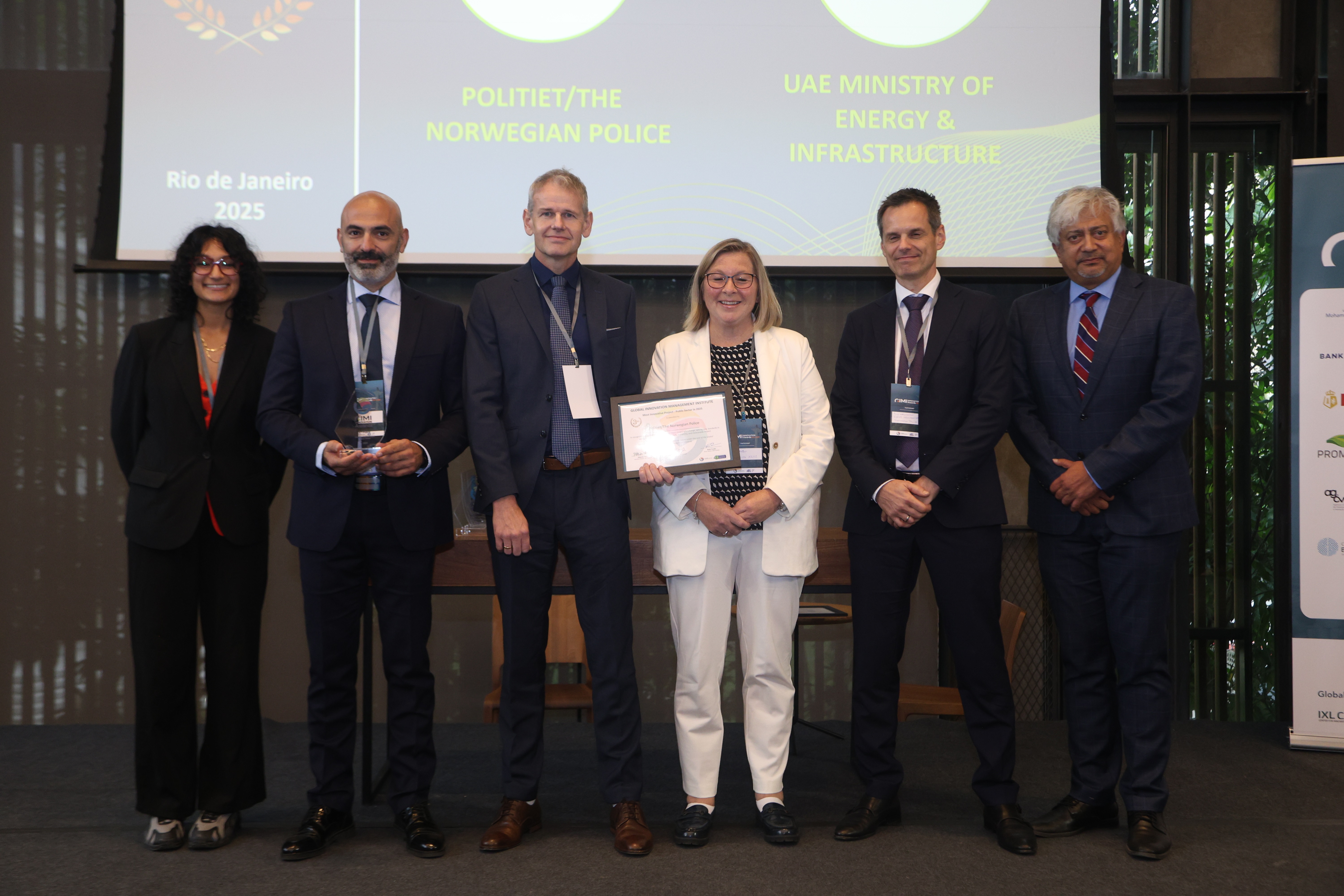 6 mennesker på en scene som tar i mot pris